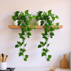 Artificial hanging vine plants with trailing green leaves in small pots