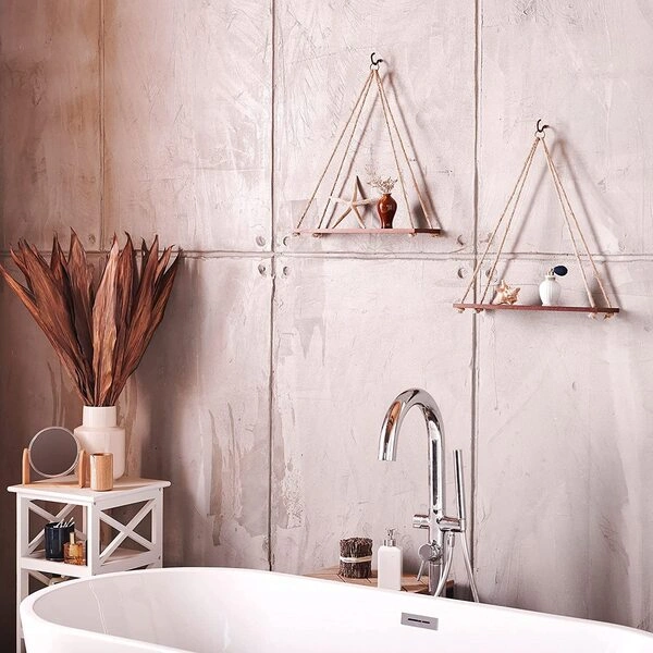 A beautiful set of Adjustable Rope Hanging Shelves displayed on a brightly lit living room wall.