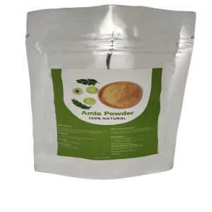 Package of pure organic amla fruit powder next to fresh Indian gooseberries.