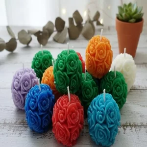A beautiful set of two Handcrafted Rose Ball Candles in a vibrant hue.