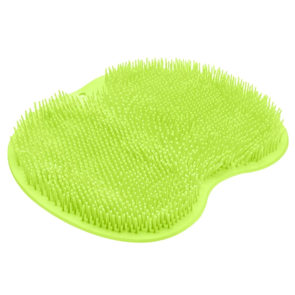 Bright green shower foot scrubber mat attached to a tiled shower floor via suction cups.