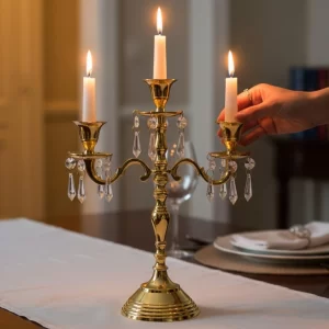 A luxurious Gold 3 Arm Candle Stand placed in the center of a decorated dining table.