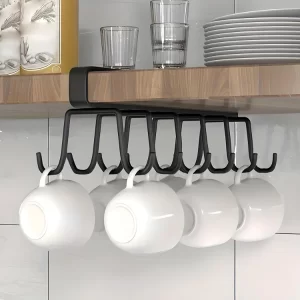 The Boniry Under Cabinet Hook Organizer installed in a kitchen, holding ceramic coffee mugs and tea cups securely.